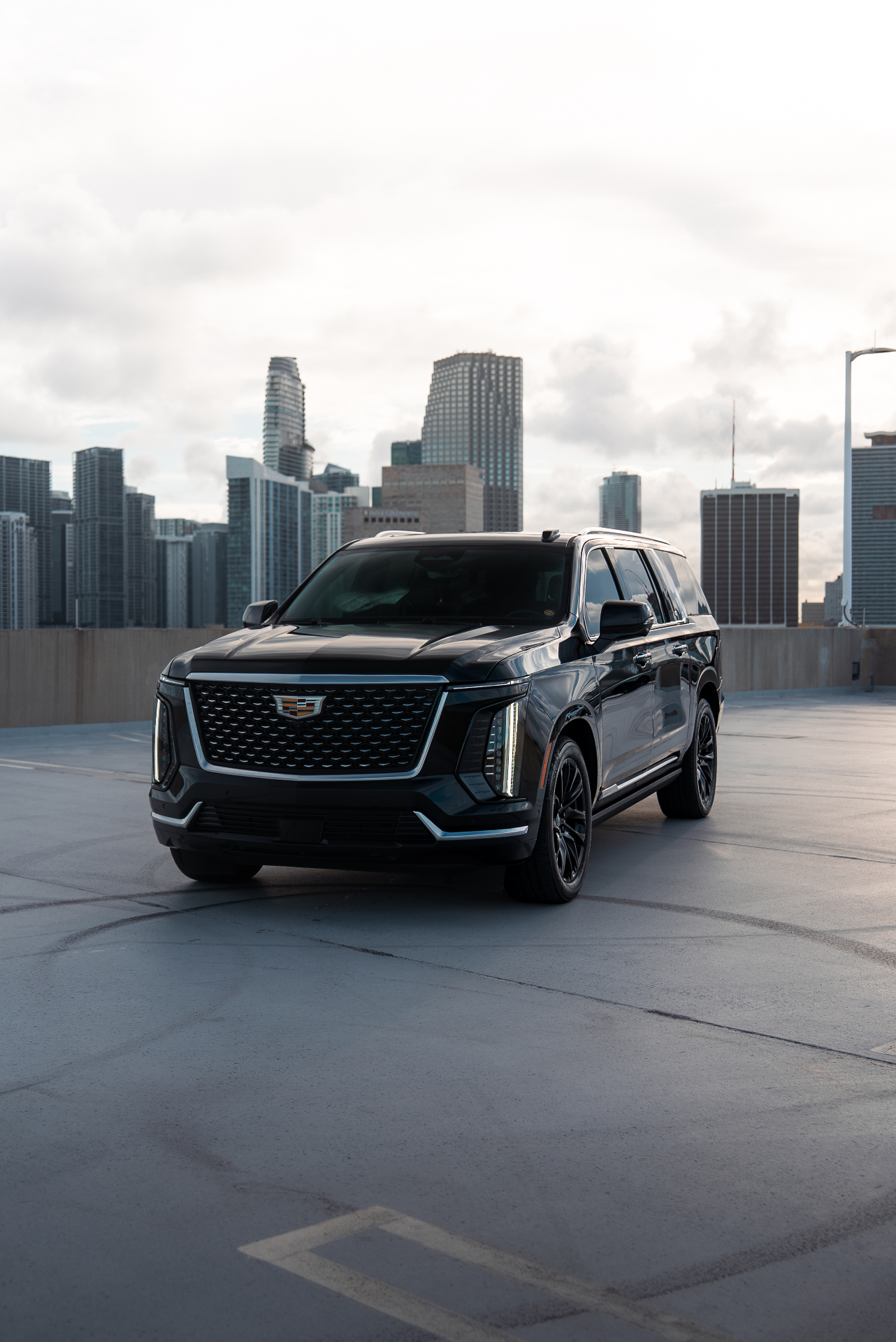 Cadillac Escalade ESV against a city skyline